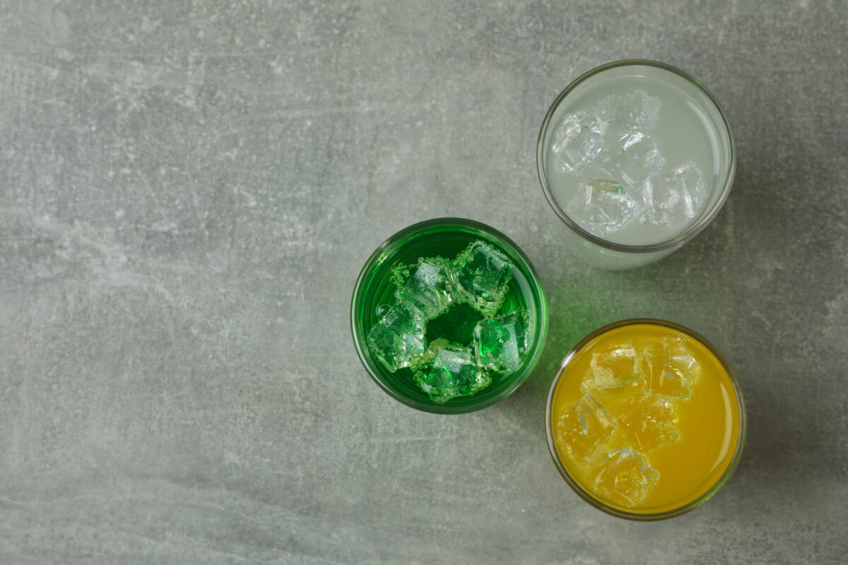 The 6 Worst Foods to Eat If You Have a Sensitive Stomach 4 Glasses of different soda on gray background