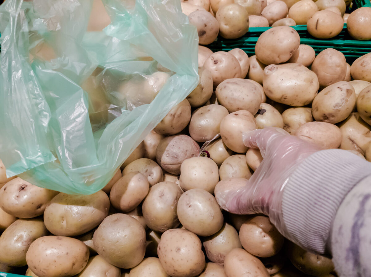 10 Foods with Surprising Secrets You Didn't Know 2 Closeup photo of buyer choosing organic potatoes in grocery store