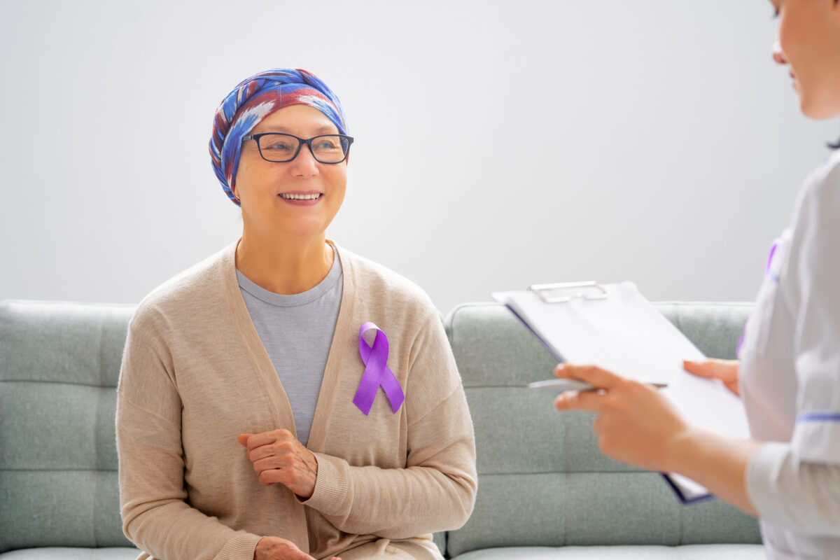 The 6 Health Hazards of Genetically Modified Foods 3 February 4 World Cancer Day. Female patient listening to doctor in medical office. Raising knowledge on people living with tumor illness.