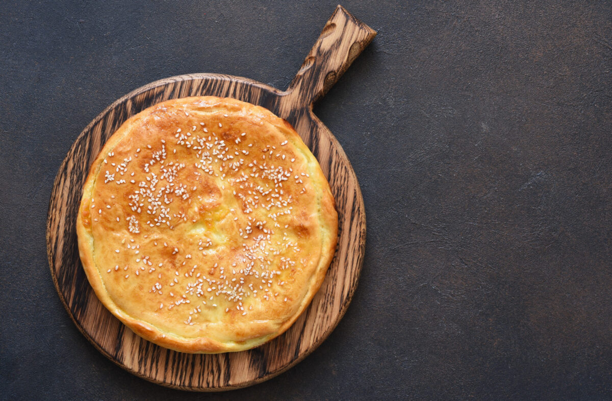 6 Pioneer Foods That Make the Wild West Look Far Less Glamorous 4 Khachapuri with suluguni cheese and cheese on a wooden board. Svehu view.