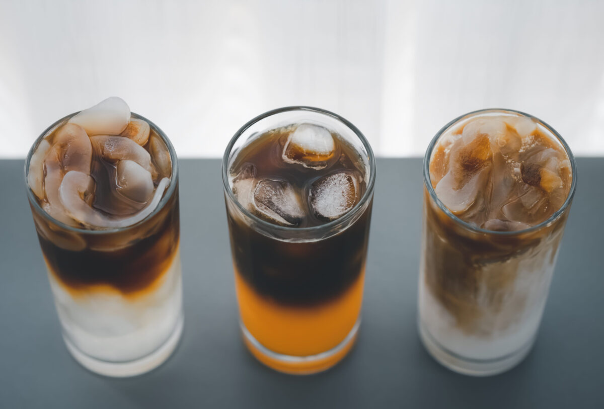 Stop Consuming These 10 Foods If You Want to Improve Your Sleep 1 top view of three glasses of different iced coffee with toddy palm, orange, and coconut milk