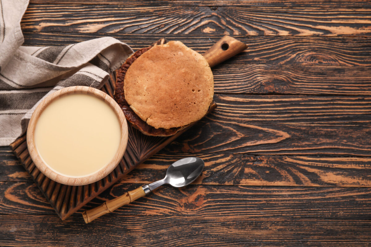 10 Regional Dishes You’ve Never Heard of But Definitely Should Try 3 Bowl with sweet condensed milk and pancakes on wooden background
