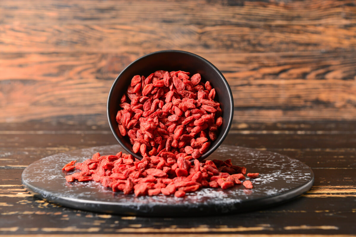 These 10 Superfoods Are Actually Super Dangerous for Your Health 2 Bowl with dried goji berries on dark wooden background