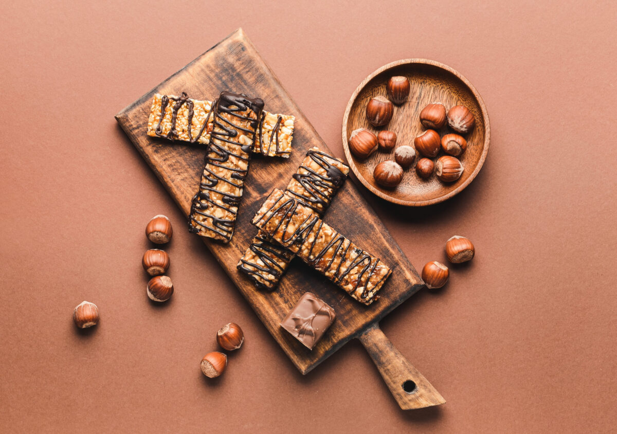 These 6 Celebrity-Approved Foods Are Actually Terrible for You 3 Board with tasty chocolate nut bars on color background