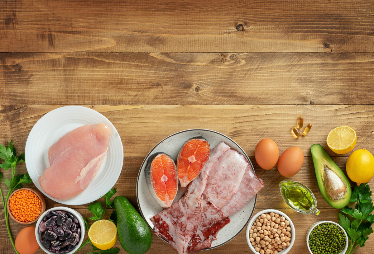 The Adverse Effects of a Vegan Diet and Understanding the Potential Risks 3 Table top view of healthy ketogenic diet foods. Wooden background, copy space.