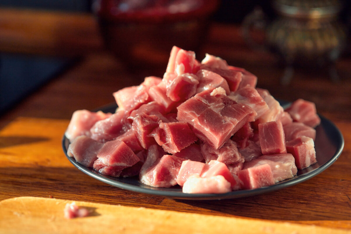 9 Foods You’re Eating That Could Be Poisoning Your Brain 3 Fresh raw diced red meat on black plate. Selective Focus, Focus one third into the meat