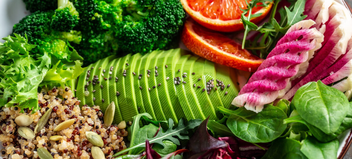 The Adverse Effects of a Vegan Diet and Understanding the Potential Risks 4 Healthy food concept. Vegan salad with vegetables, avocado, blood orange, broccoli, watermelon radish, spinach, quinoa pumpkin seeds. Food recipe background. close up.