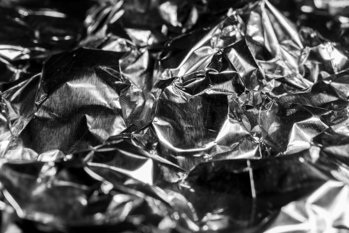 Foods You Should Never Cook in Aluminum Foil 1 Macro texture of aluminum foil. Abstract aluminum background