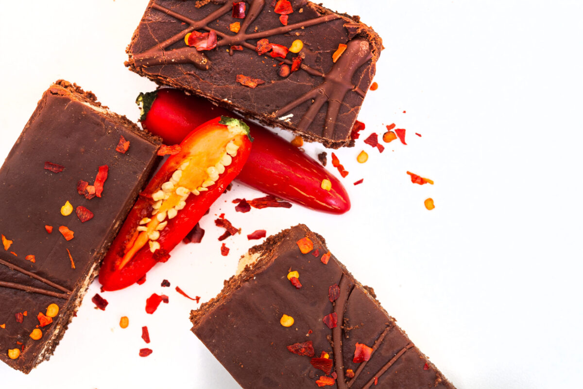 7 Unexpectedly Delicious Food Pairings You Need to Try Right Now 2 Chocolate brownies with chili peppers on a white background, top view