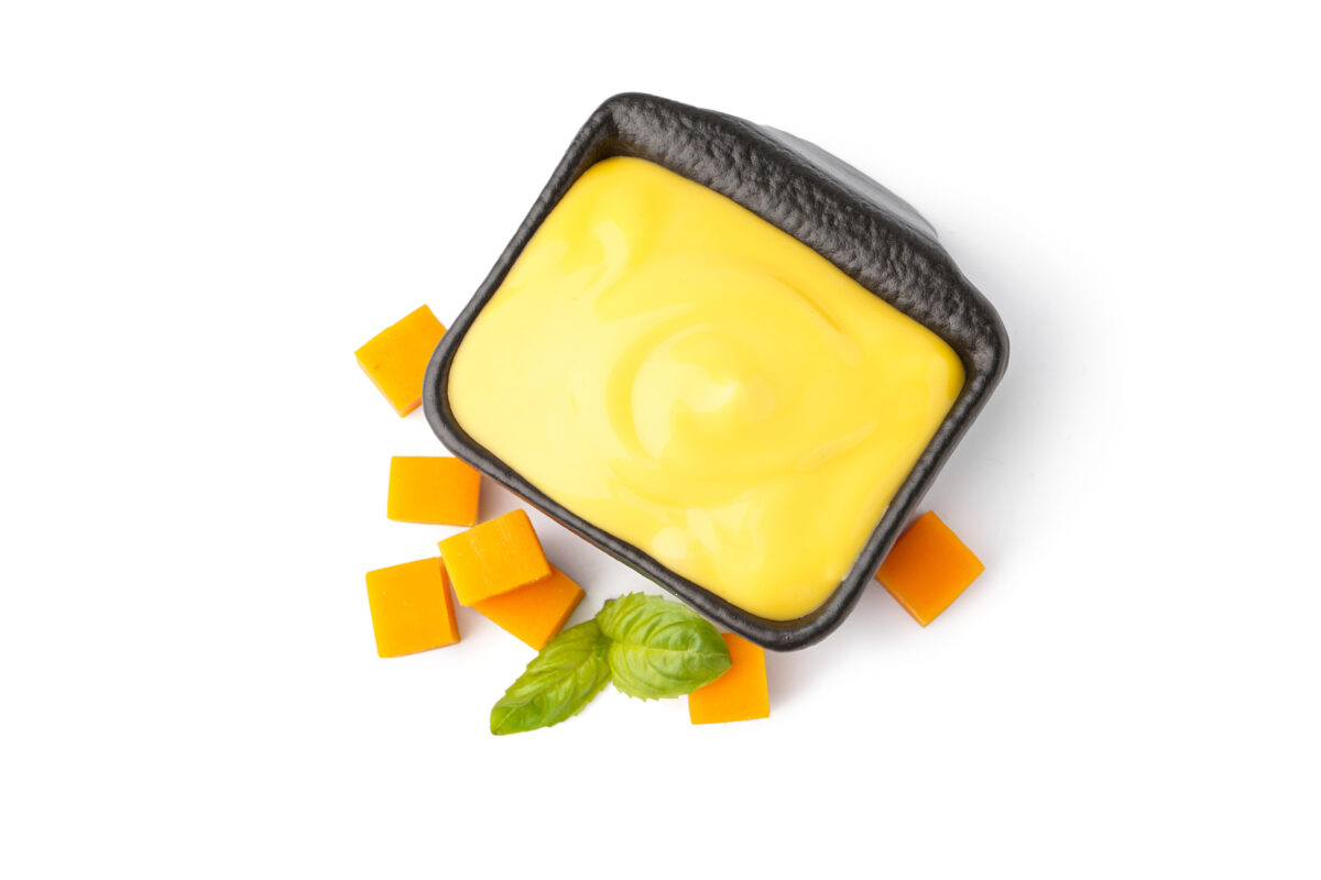 9 Fast Food Dipping Sauces That Can Ruin an Otherwise Good Order 3 Bowl with tasty cheddar cheese sauce on white background