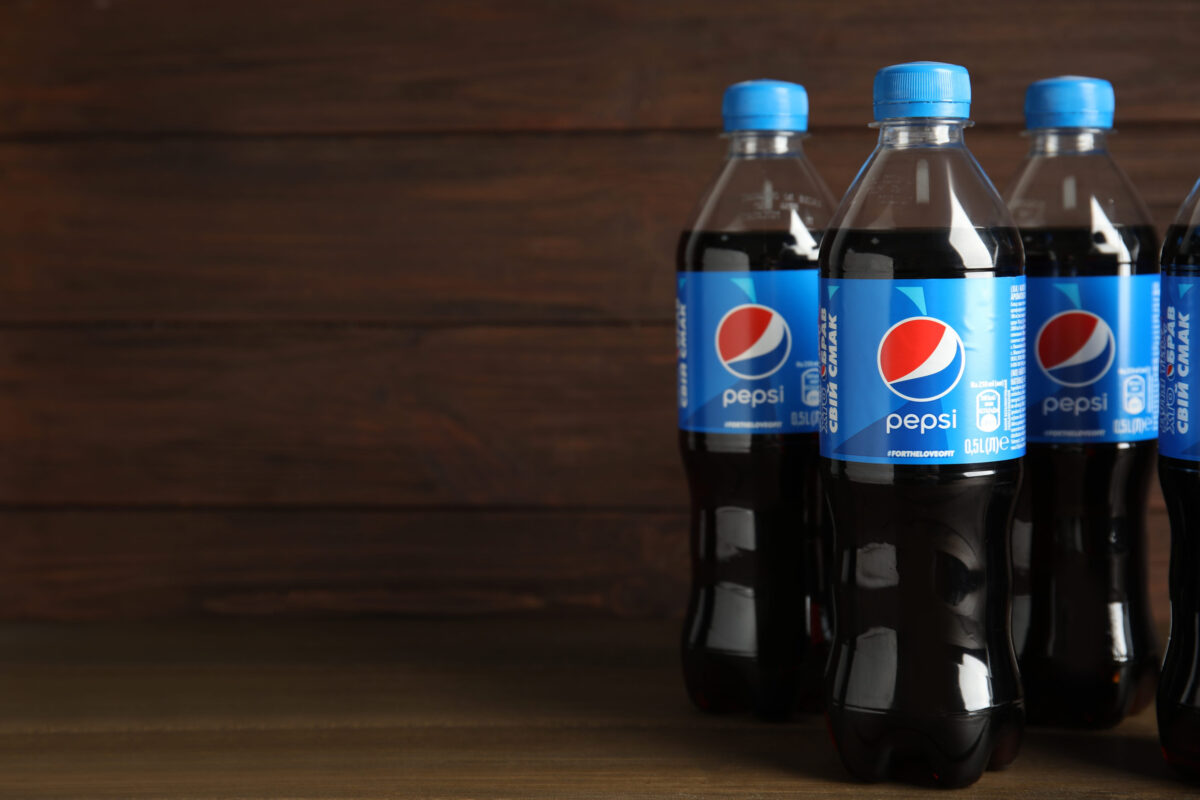 11 Discontinued Foods We Miss From the 90s 2 MYKOLAIV, UKRAINE - FEBRUARY 10, 2021: Bottles of Pepsi on wooden table. Space for text