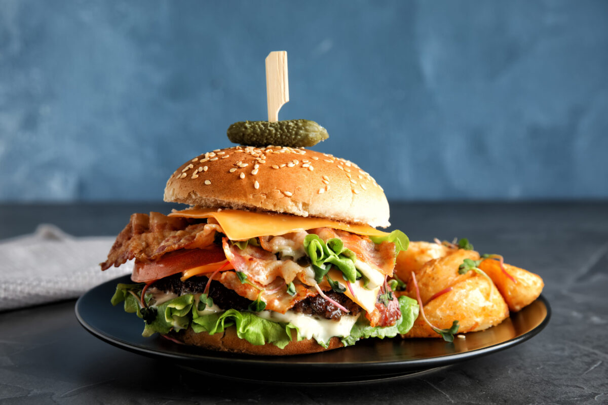 9 Foods You Should Never Order at a Chain Restaurant 3 Tasty burger with bacon served on table