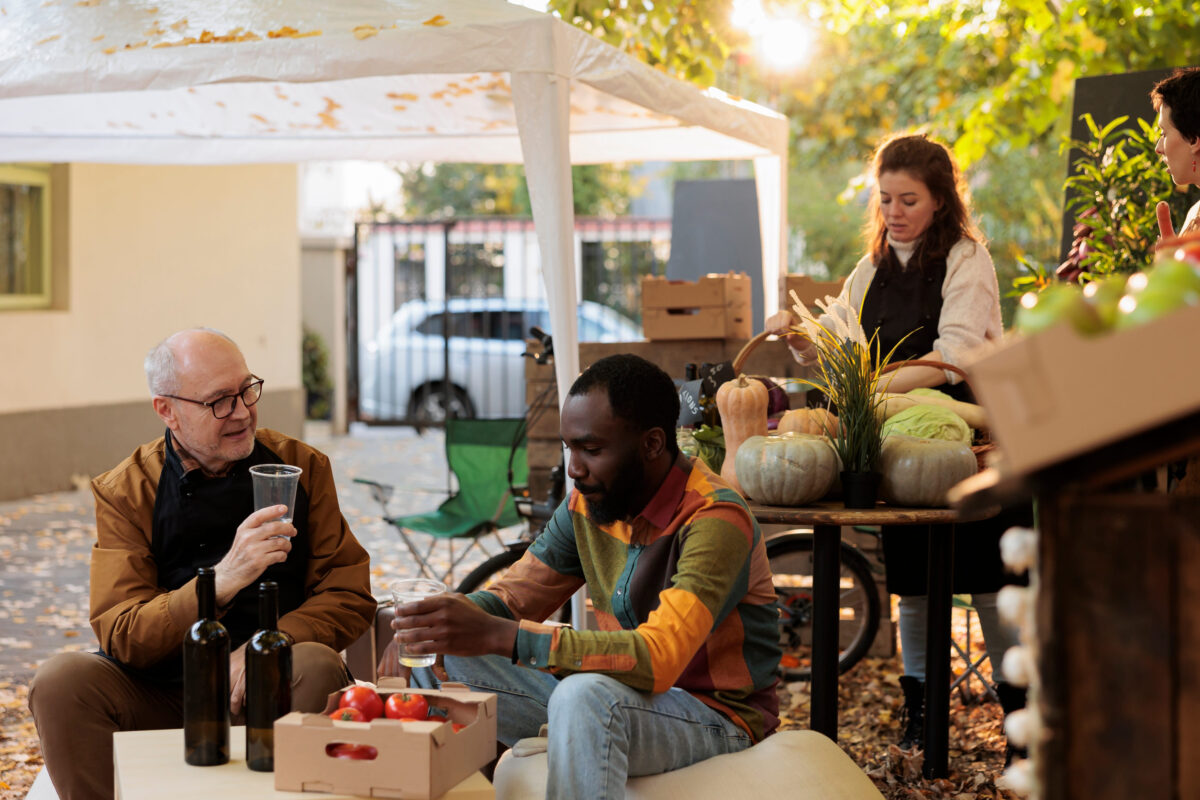The Rude Behaviors That Can Completely Ruin a Potluck 1 Young African American guy customer tasting homemade natural wine while sitting at table with winemaker at farmers market. Consumer sampling local produce while visiting organic food festival