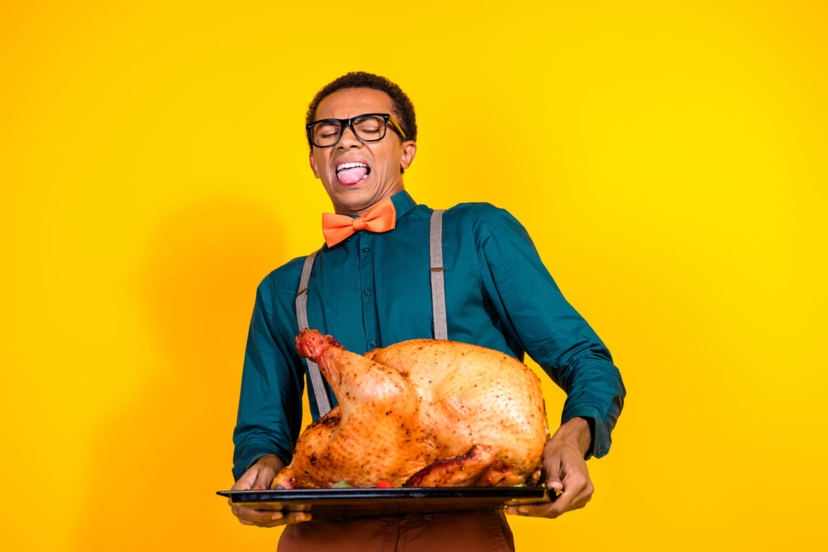 7 Worst Kitchen Disasters That Ruined Family Gatherings 1 Photo of guy hold turkey dish for thanksgiving feel disgusted isolated on yellow color background