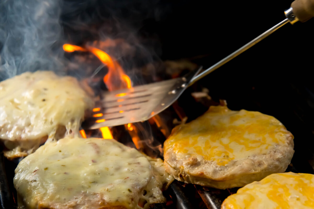 11 Biggest Mistakes Everyone Makes When Cooking Burgers 3 cheeseburgers on the grill, BBQ