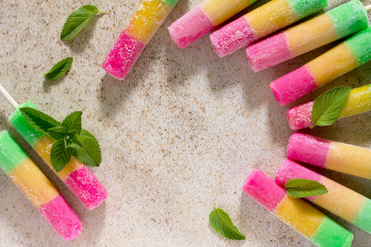 10 Once-Popular Foods People Stopped Eating and Why They Fell Out of Favor 4 Delicious fruit ice, cherry, orange and apple and ice on the stone background. Space for your text.