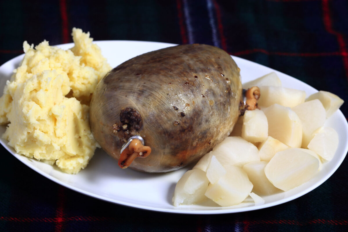 8 Shocking Foods Banned in the United States 2 A cooked haggis with diced turnips and mashed potatoes - the traditional