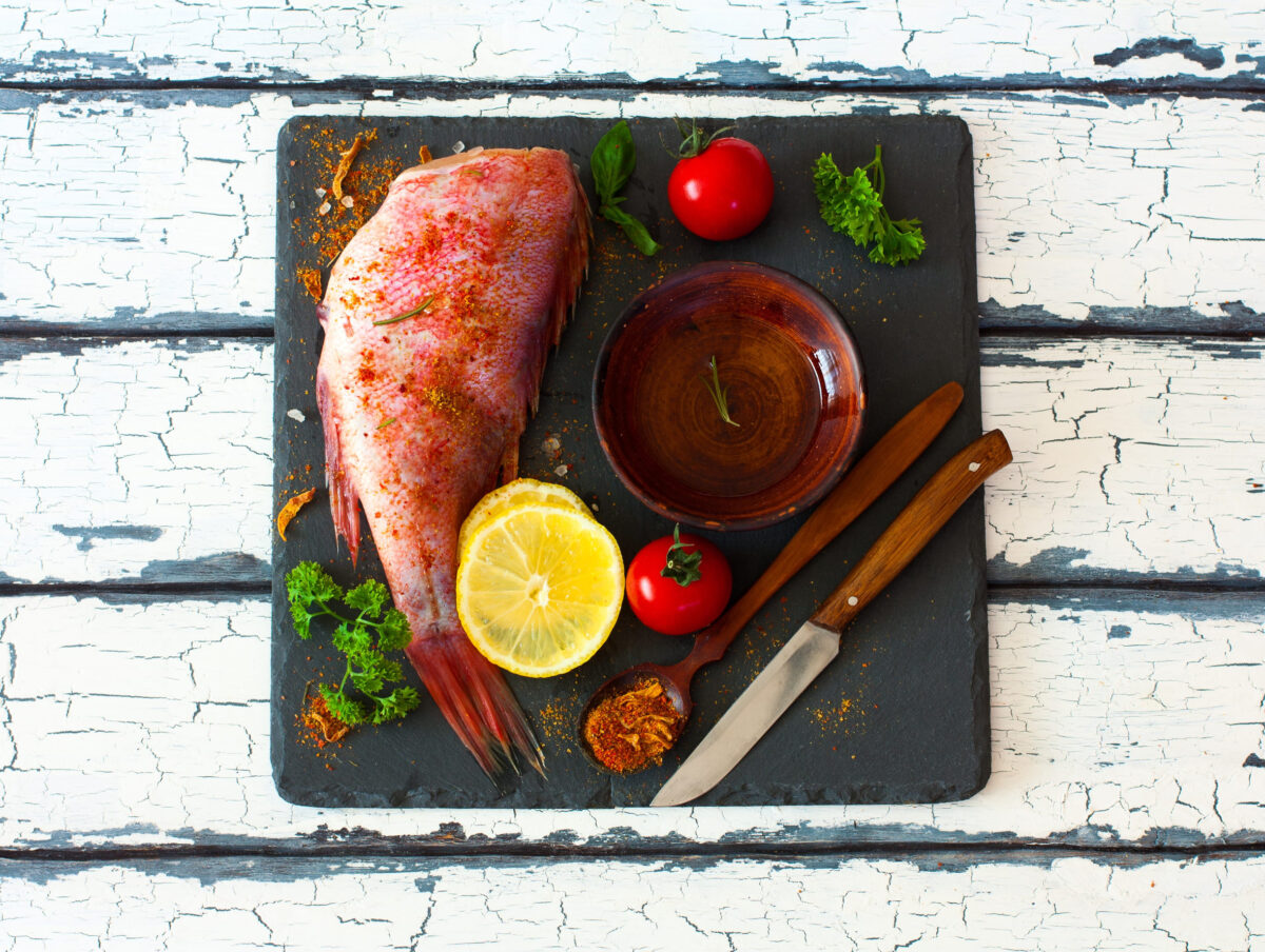 10 Underrated Fish You Should Try Before Buying Another Salmon Fillet 1 Fillet of red grouper and spices, tomatoes, parsley , lemon and olive oil over natural background