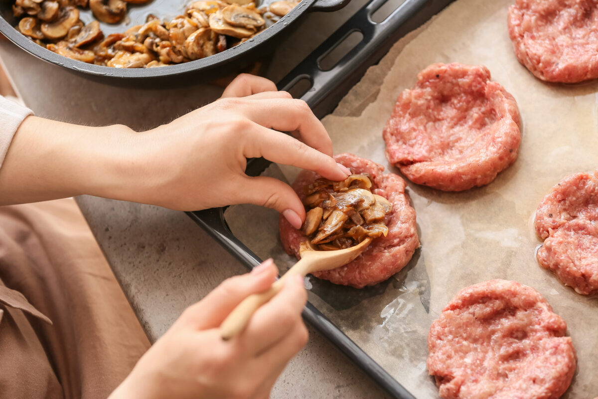 11 Biggest Mistakes Everyone Makes When Cooking Burgers 2 Woman mushrooms into minced meat putting boat at table