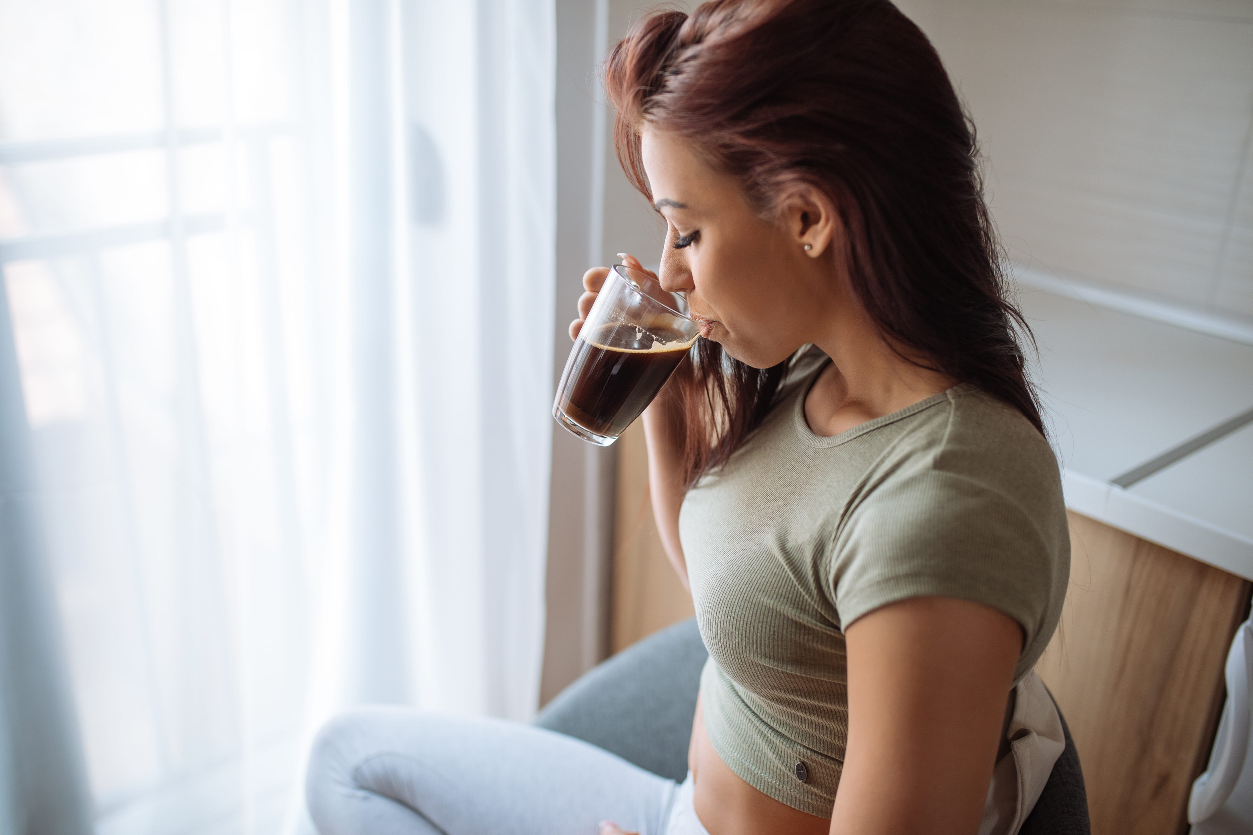 Shot of an attractive young woman enjoying drinking coffee in the morning.