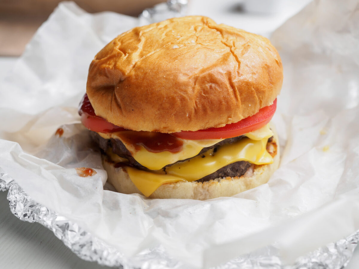 16 Fast Food Cheeseburgers That Pack More Damage Than You Expect 1 Double cheese burger with beef and tomatoes on paper