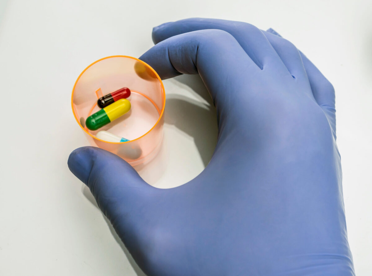 The 6 Health Hazards of Genetically Modified Foods 4 Doctor holds glass with medication for palliative care in hospital, conceptual image