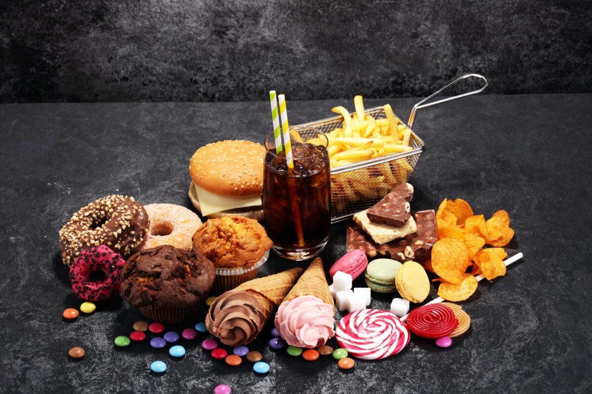 8 Foods That Could Be Sabotaging Your Immune System 2 Unhealthy products. food bad for figure, skin, heart and teeth. Assortment of fast carbohydrates food.