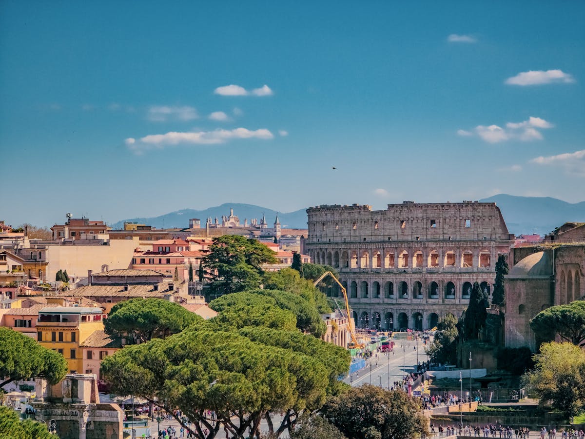 7 Overcrowded Destinations to Skip This Summer 4 A breathtaking view of Rome featuring the iconic Colosseum on a sunny day.