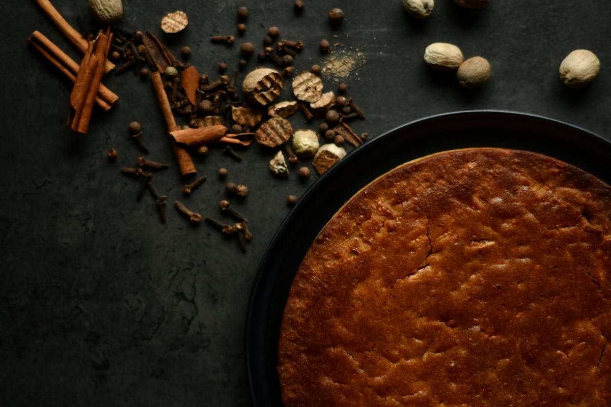 10 Everyday Foods That Could Be Toxic or Even Deadly 2 A close-up shot of a freshly baked pie with assorted spices on a rustic dark surface.