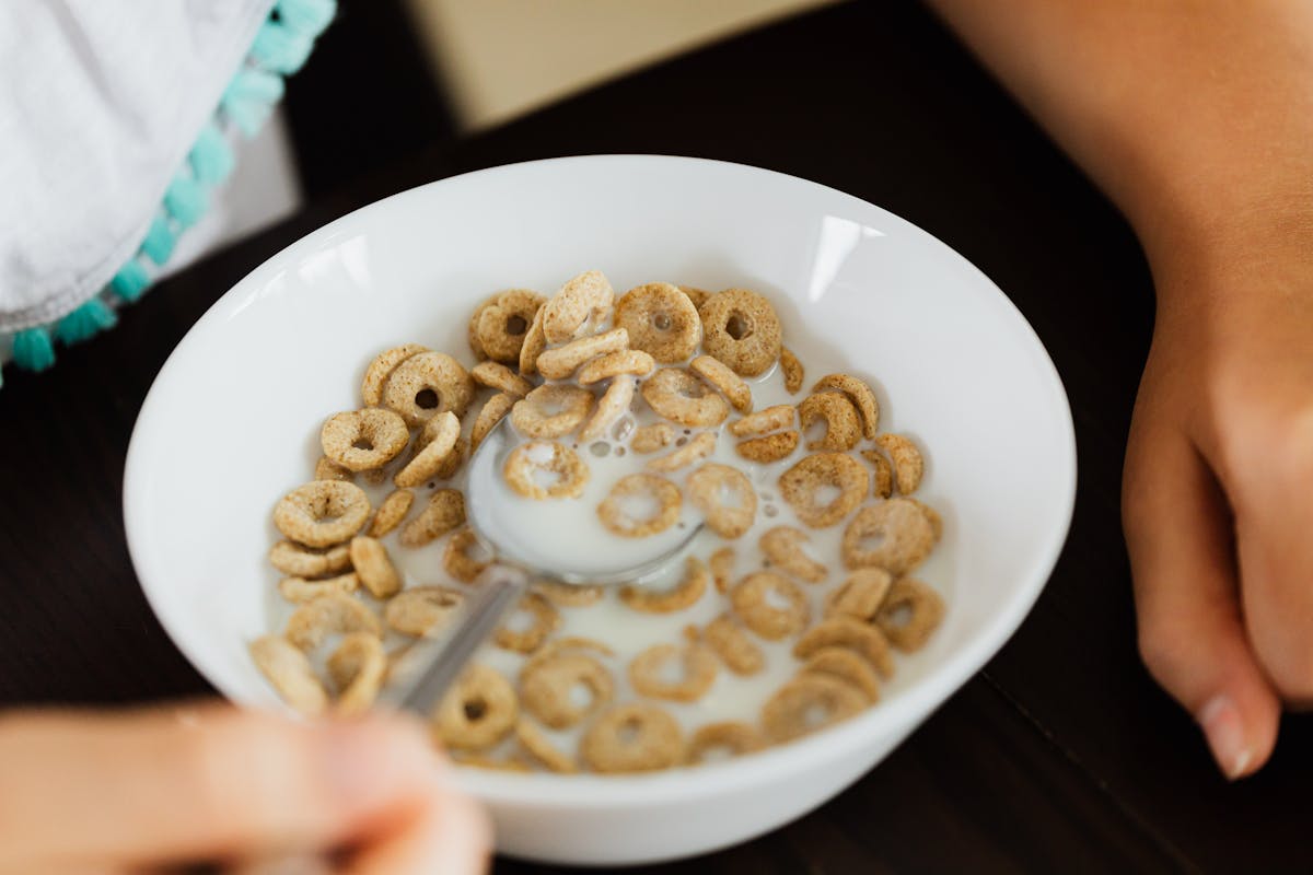 These 10 Morning Foods Are Silently Destroying Your Body 1 A close-up view of a bowl of cereal with milk, captured from above.