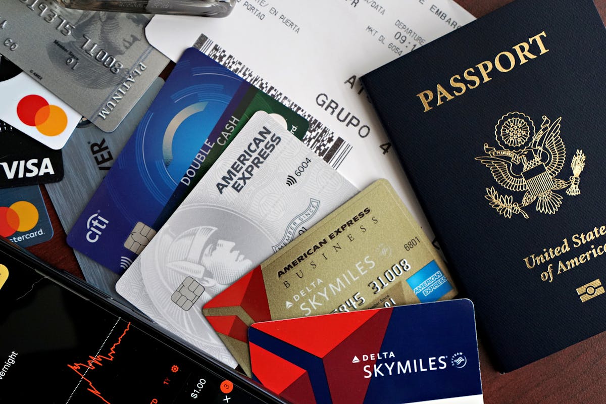 14 Common Travel Mistakes That Will Destroy Your Budget 2 A collection of travel essentials including a passport, credit cards, and a boarding pass. Ideal for travel and finance concepts.