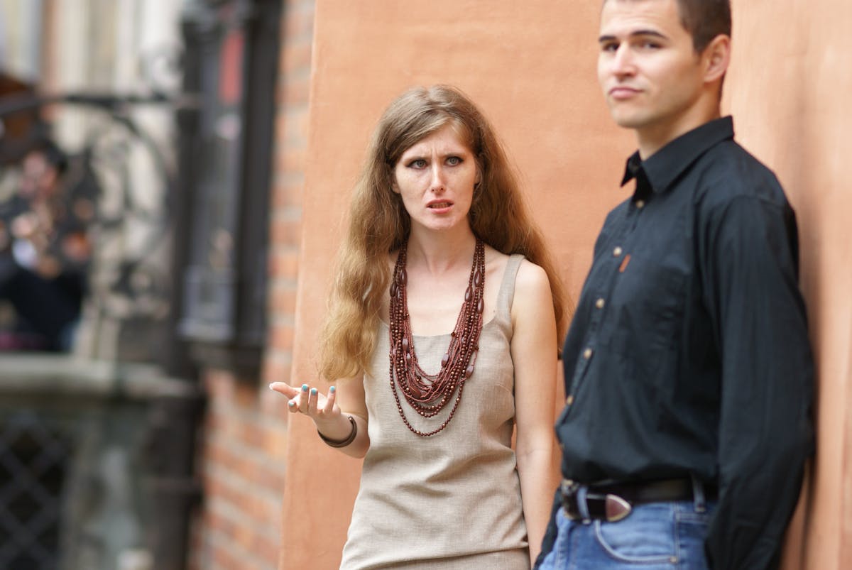 10 Critical Signs Your Marriage Is Heading for Divorce 2 A couple engaged in a conversation outdoors in an urban setting.