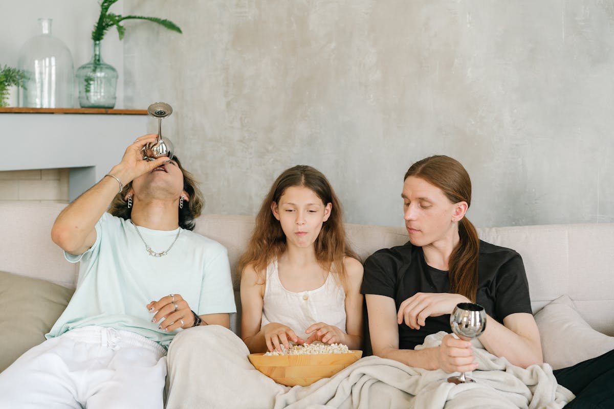 9 Reasons People Avoid Seeking Mental Health Care 4 A diverse group of friends enjoying popcorn and drinks together on a cozy indoor sofa.