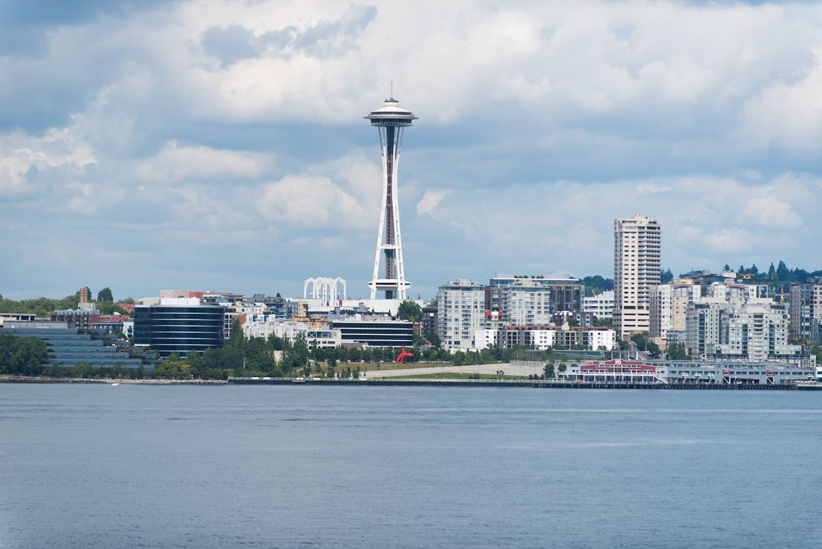 Top 10 Worst States in The US for Middle-Class Taxpayers 1 A scenic view of the Seattle skyline featuring the iconic Space Needle against a cloudy sky.