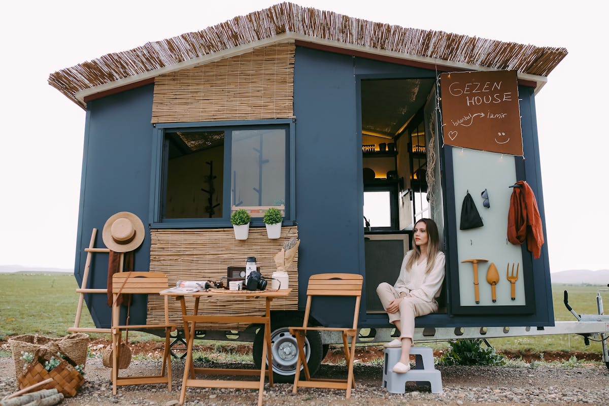 11 Outrageous Trends That Defined the Last Decade 4 A woman enjoys a peaceful moment in a stylish mobile home, showcasing boho design.
