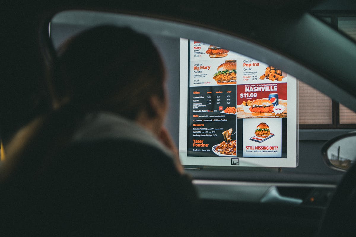 10 Jobs Robots Are Taking From Humans 2 A woman in a car views the menu at a fast food drive-thru, ready to order her meal.