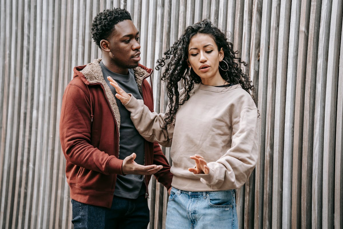 8 Everyday Mistakes That Slowly Undermine Your Marriage 4 Annoyed ethnic girlfriend with curly hair pushing away concerned African American boyfriend while having conflict on street near wooden wall during breakup