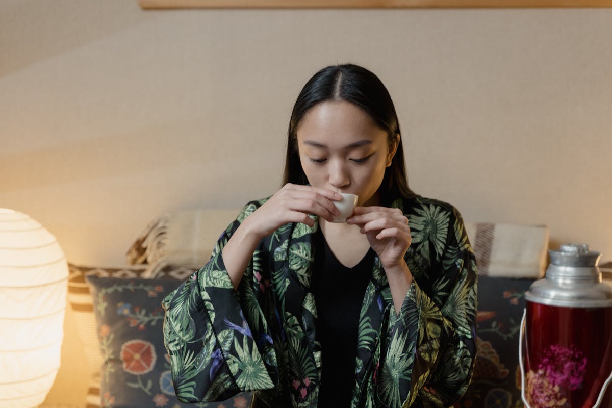 9 Mind-Blowing Facts You Won’t Believe Are True 1 Asian woman enjoying a traditional tea ceremony indoors with serene ambiance.