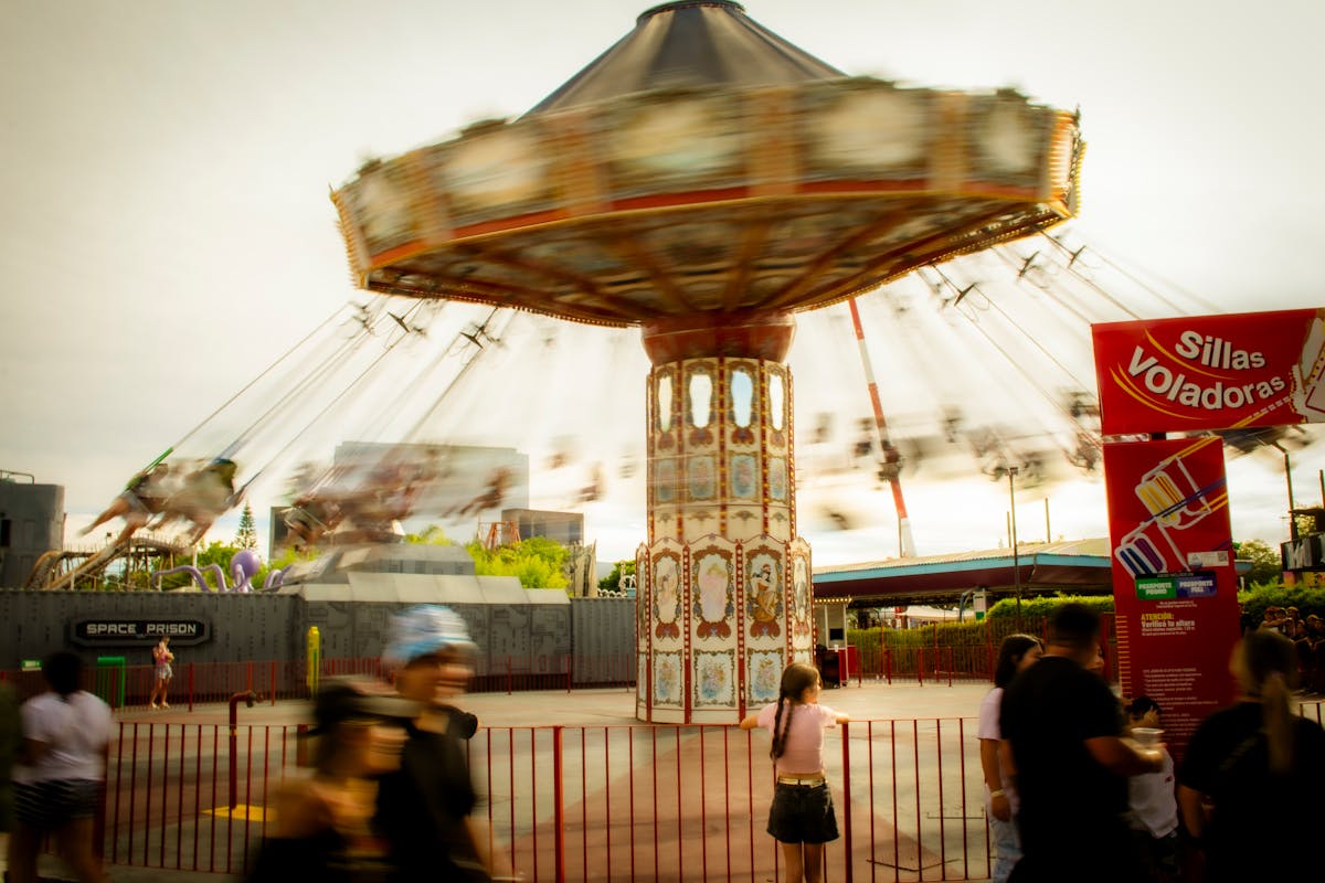 10 Everyday Activities That Can Alter Consciousness and Perception 2 Blurred motion of a swing ride in an amusement park with people watching.