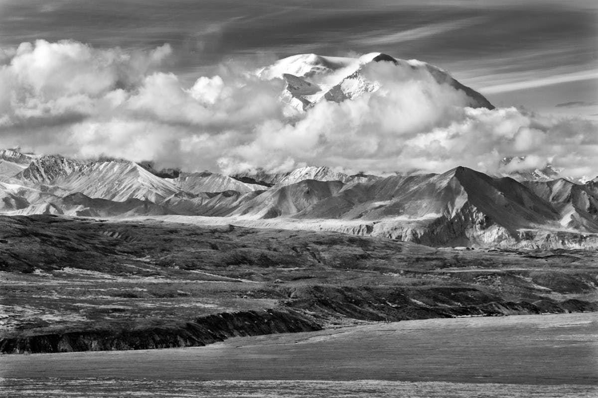 The 10 Most Dangerous Hikes in the World 2 Breathtaking black and white landscape of Denali with clouds and rugged terrain.