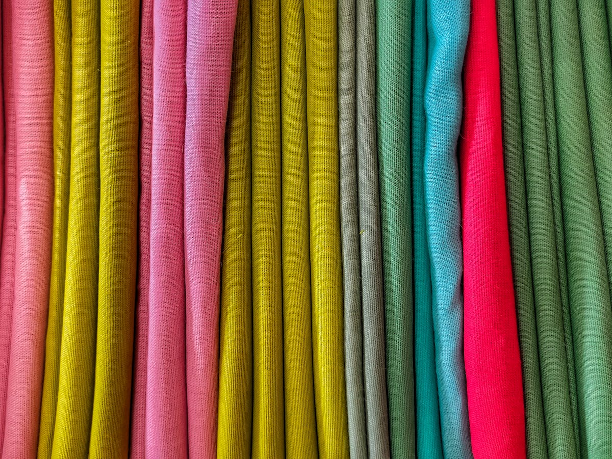10 Things You’re Ruining by Cleaning Them With Disinfecting Wipes 5 Bright and colorful textile fabric folds in a vibrant pattern, highlighting a variety of hues.