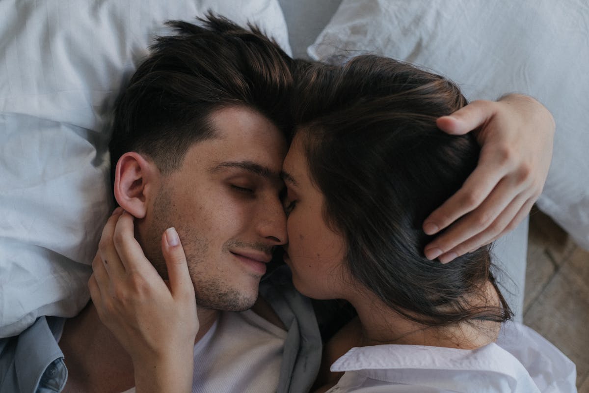 10 Mistakes to Avoid for a Stronger, Healthier Relationship 1 Close-up of a loving couple embracing and resting peacefully in bed.