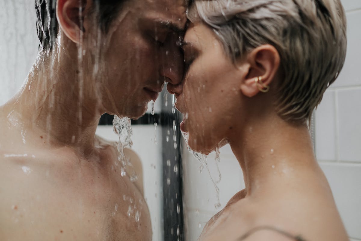 10 Odd Habits That Make Relationships Stronger 4 Close-up of a loving couple sharing a tender moment in the shower.