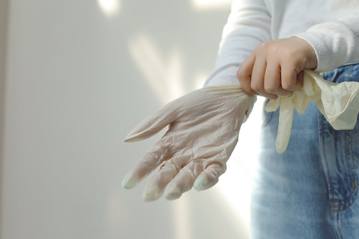 10 Common Allergies That You Shouldn’t Ignore 4 Close-up of a person wearing protective latex gloves for hygiene and safety.