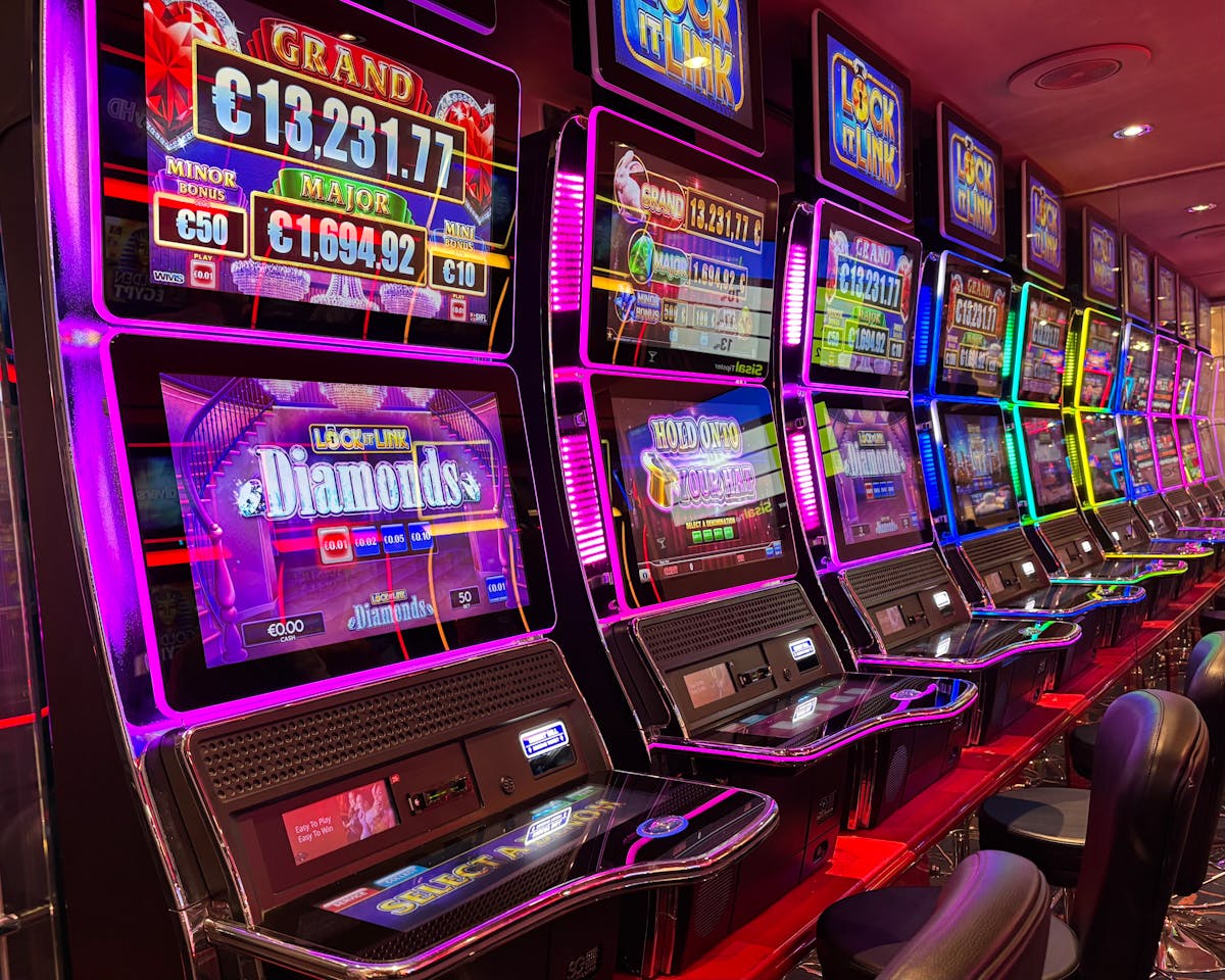 10 Baby Boomer Behaviors That Annoy Millennials and Gen Z 4 Colorful slot machines lined up in a casino with neon lights and jackpot displays.