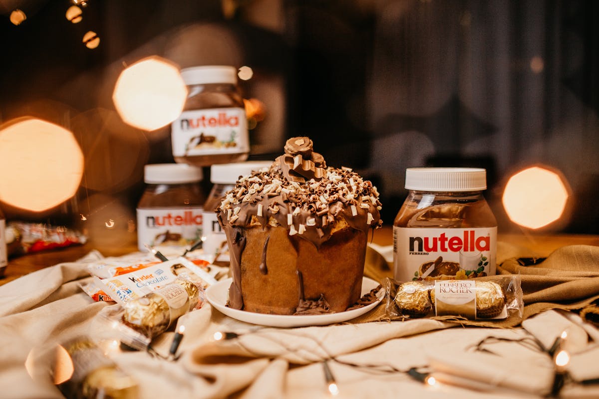 8 of the Most Unusual Things Ever Stolen 3 Decadent chocolate cake with Nutella jars and assorted candies on a warm, indulgent display.