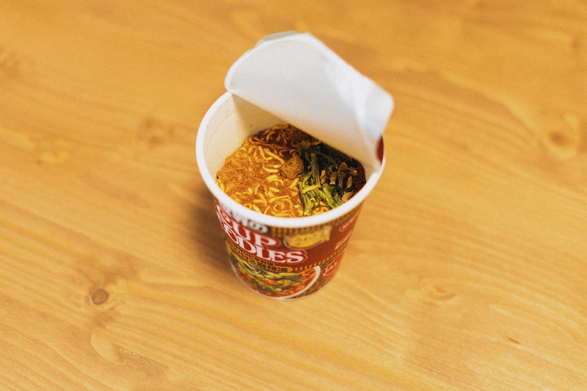 12 Unhealthy Foods to Avoid for Better Health 4 Delicious cup of instant noodles ready to prepare, showcasing Japanese fast food culture.