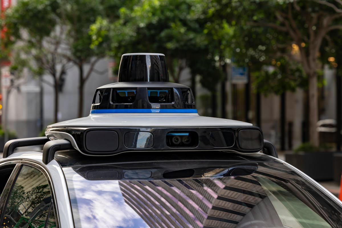 10 Jobs Robots Are Taking From Humans 3 Detailed view of sensors atop an autonomous car, showcasing advanced technology in an urban setting.