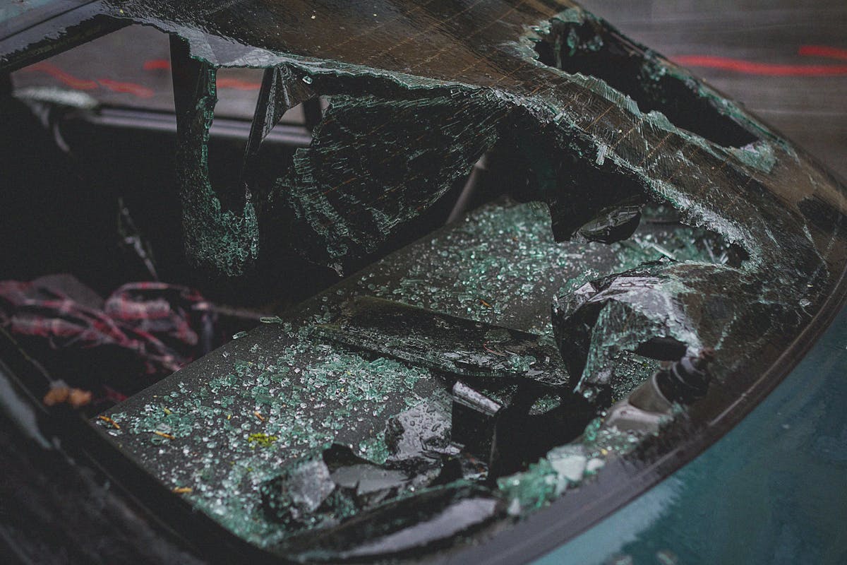 10 Heavy Metal Scandals That Shaped the Genre 3 Detailed view of shattered car windshield after accident, emphasizing damage and broken glass.