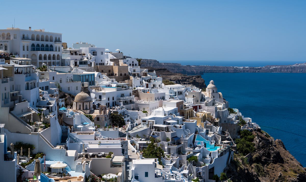 7 Overcrowded Destinations to Skip This Summer 2 Discover the beauty of Santorini's white-washed buildings against the blue Aegean Sea.